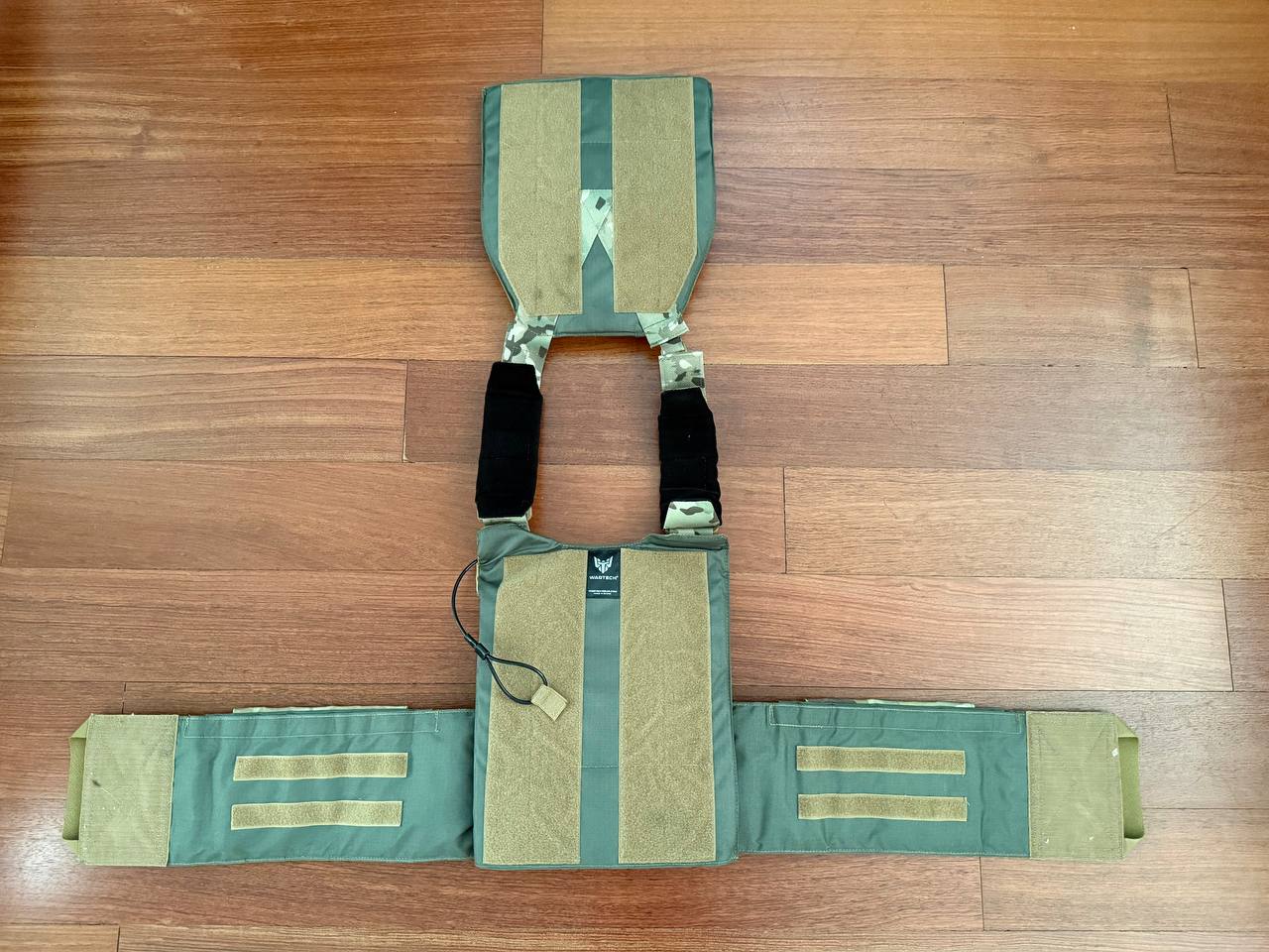 Russian Wartech - TV-124 Vest – Multicam - Size S/M laid flat on wooden floor showing front and back panels and adjustable straps in multicam pattern with tan accents.