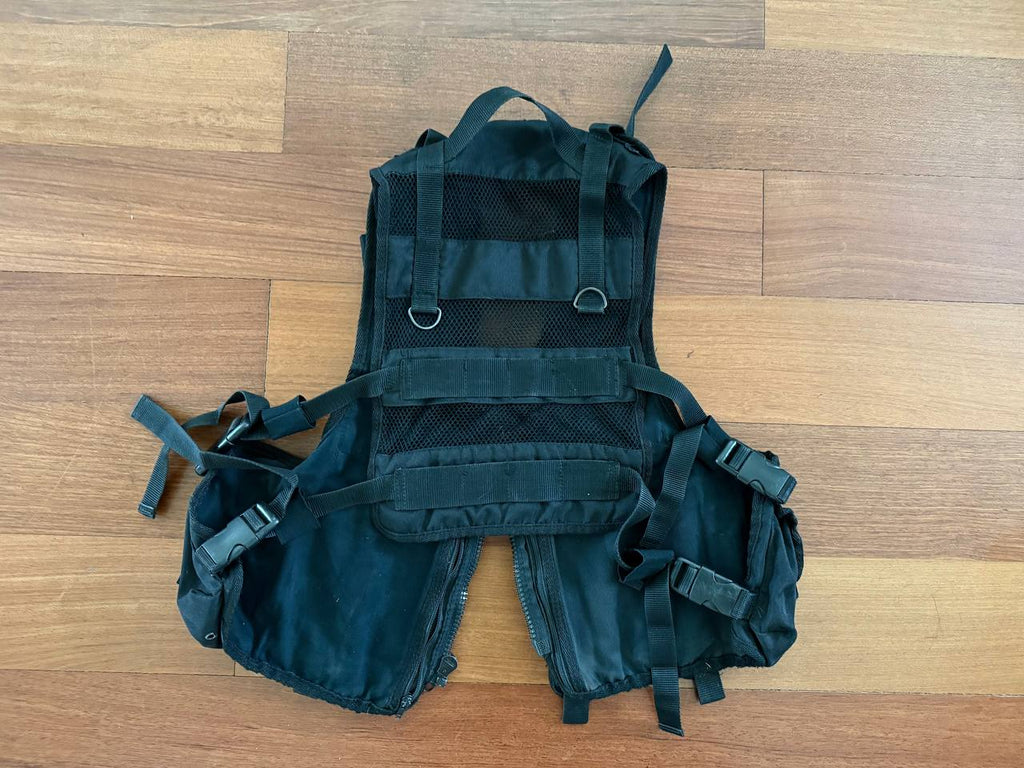 Russian ANA - "Gorod-2" Tactical Vest – Black laid flat on a wooden surface, featuring adjustable straps, durable fabric, and mesh ventilation panels, designed for practical tactical use.