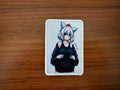 Patch featuring a Russian Wolf-eared Anime Girl character wearing a dark jacket, designed as the Russian Wolf-eared Anime Girl - Military Patch with a white border on a wooden surface.