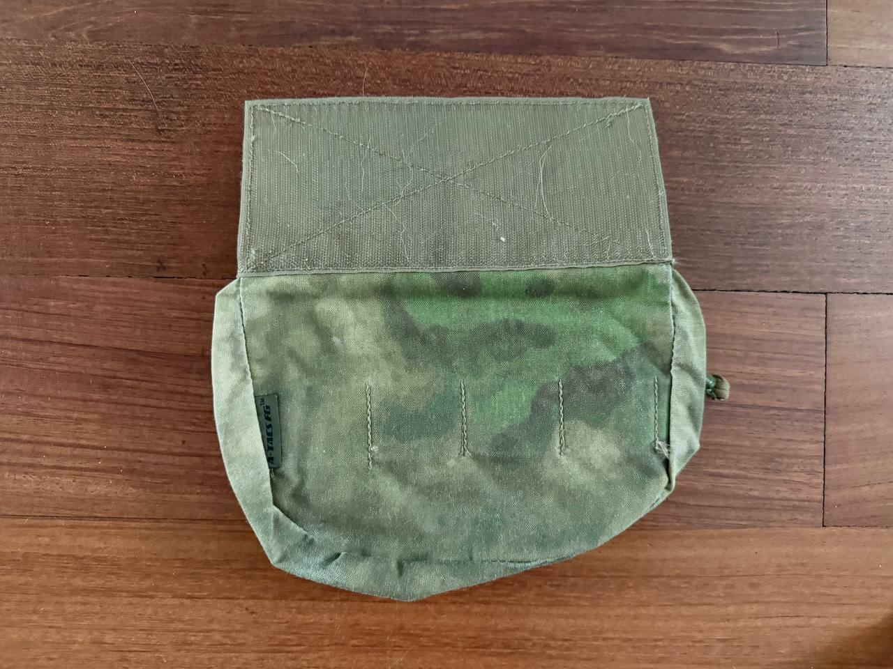 Russian Ars Arma Dangler Pouch – A-TACS FG (Pre-War Production) displayed open on a wooden surface, featuring a green camouflage pattern typical of Russian surplus gear.