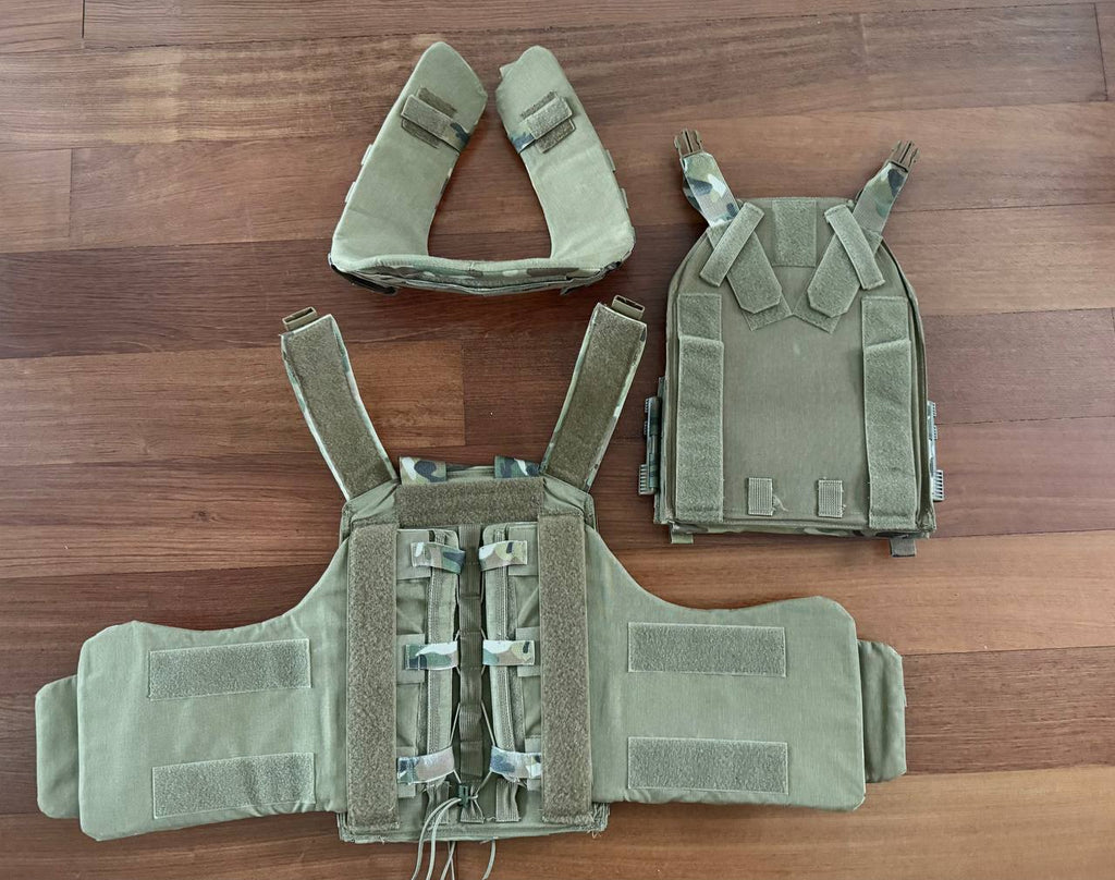 Russian Gear Craft - "Atom 1.0" Plate Carrier - Multicam - Size M laid out on a wooden surface, showing front, back, and shoulder components in camouflage tactical gear style.