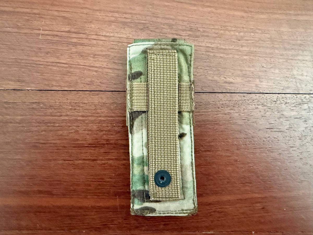 Russian Ana Tactical Single Pistol Mag Pouch - Multicam - Old Gen FSB laid flat on a wooden surface showing durable fabric and secure strap with button closure.