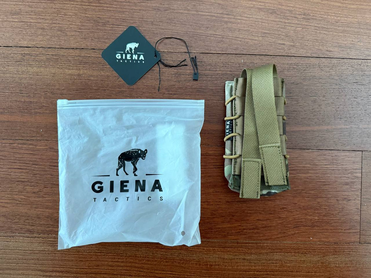 Russian Giena Tactics Open Top Single Mag Pouch - Multicam with a branded tag and white packaging bag, displayed on a wooden surface.