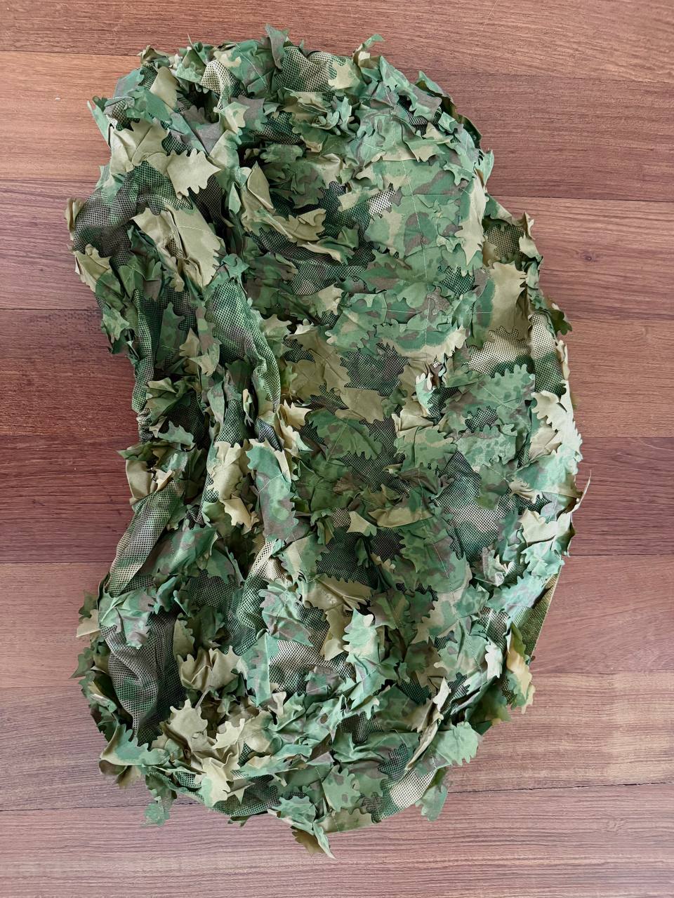 Russian Sokl Leaf Backpack Cover (60L) - Olja Pattern shown in green and beige camouflage with leaf-like fabric overlays designed for outdoor concealment in wooded environments.