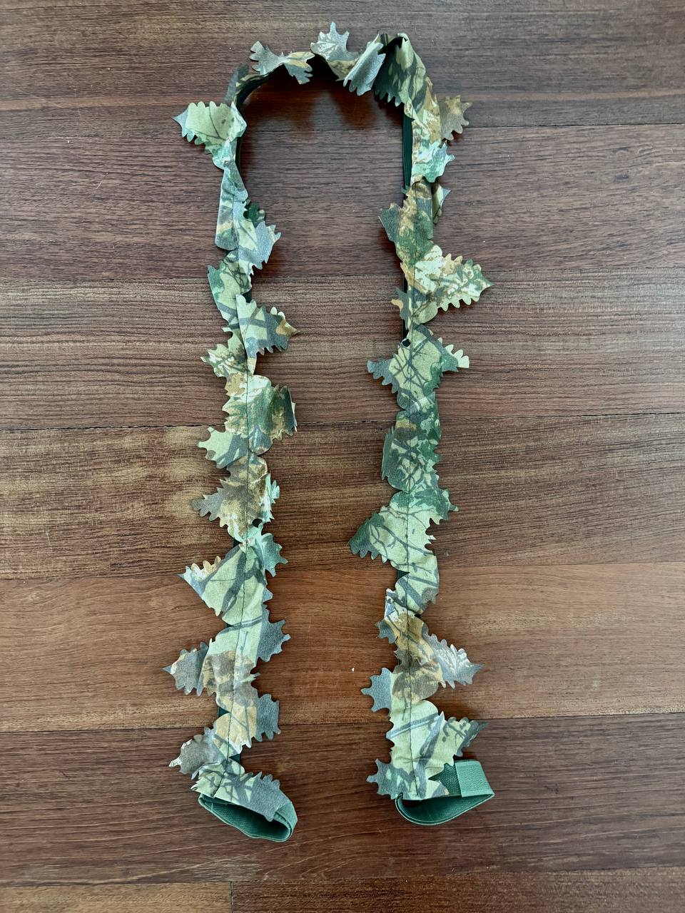 Russian Leaf Gun Stripe - 140cm - Autumn Pattern camo strap with leaf shapes designed for concealment, displayed on a wooden surface.