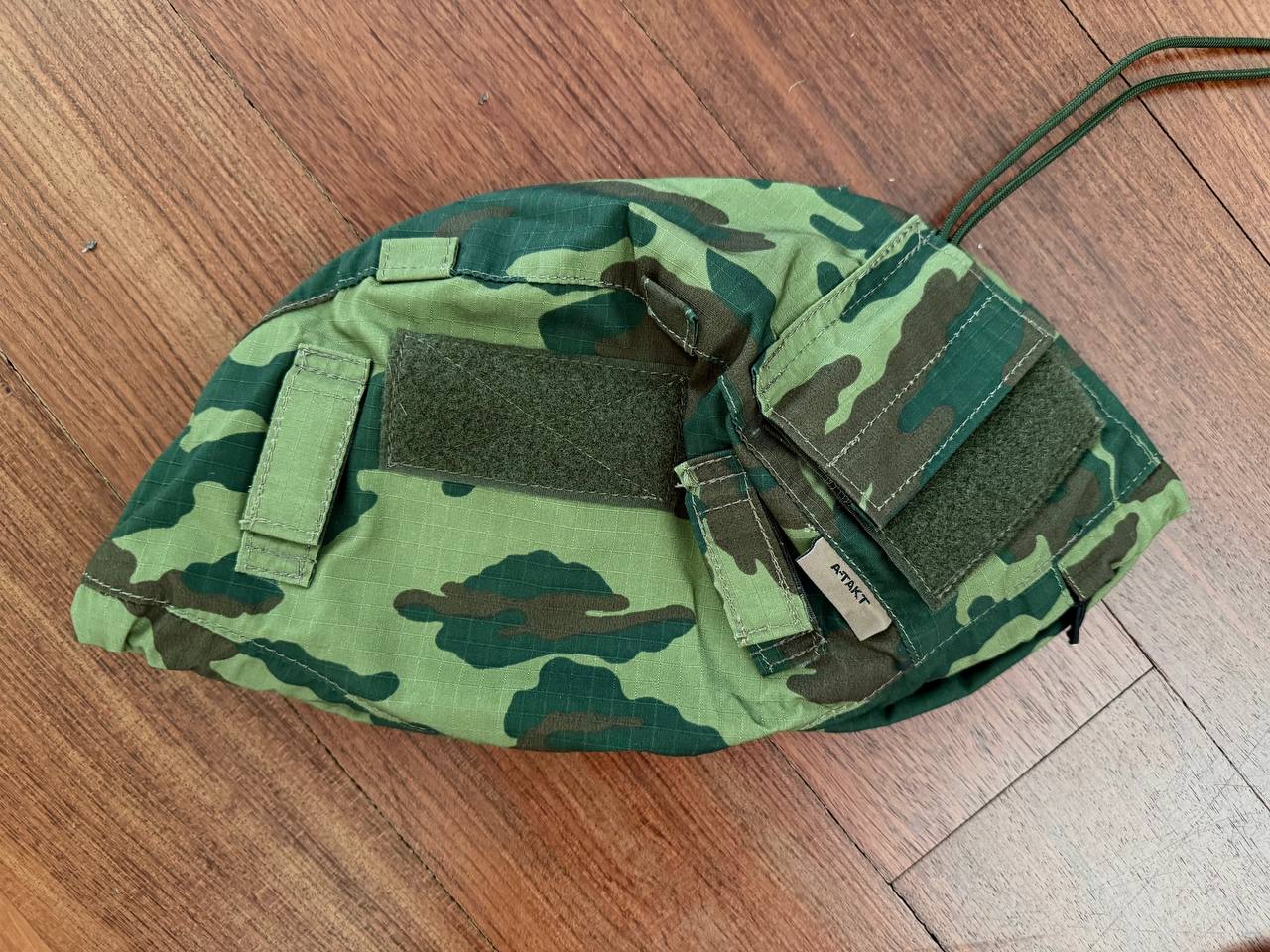 Russian 6b47 Helmet Cover - VSR98 - Size 2 in green camouflage pattern designed for Russian surplus helmets, displayed on a wooden floor background.