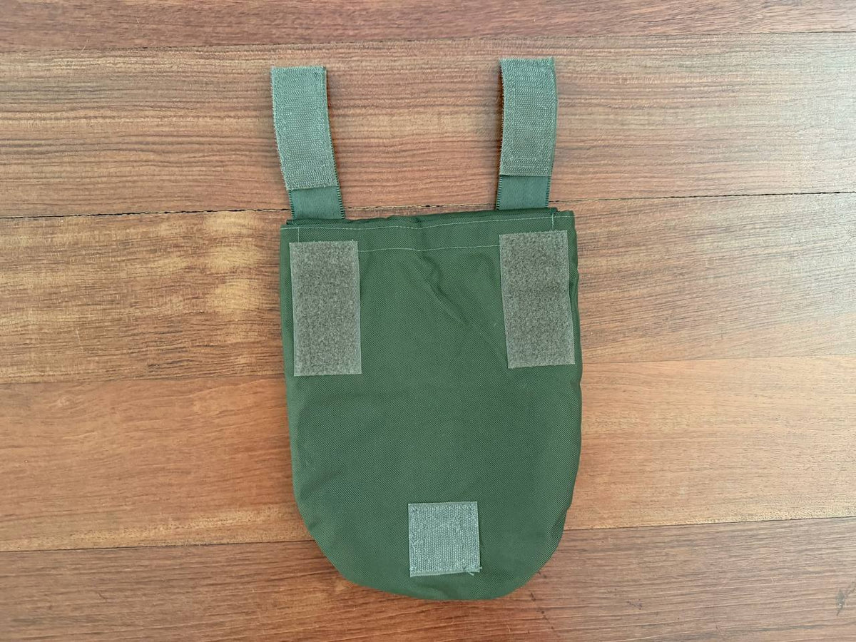 Ukrainian Korsar Groin Pad Cover - Olive Drab displayed on wooden surface, designed with durable olive drab fabric and Velcro straps for secure attachment.