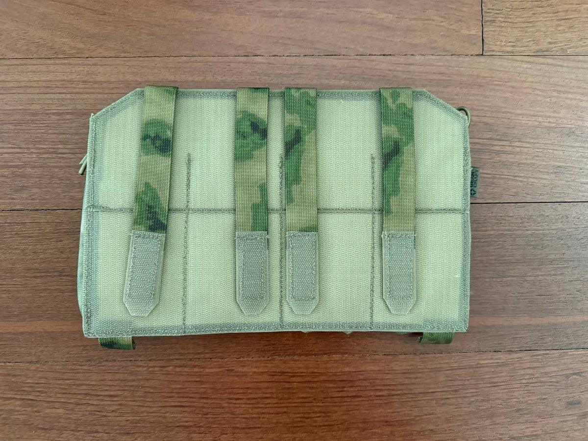 Russian Gear Craft HARD Quad AK/AR Magazine Placard - ATACS FG/Moss laid flat on wooden surface showing camouflage fabric with four retention straps for secure magazine storage.