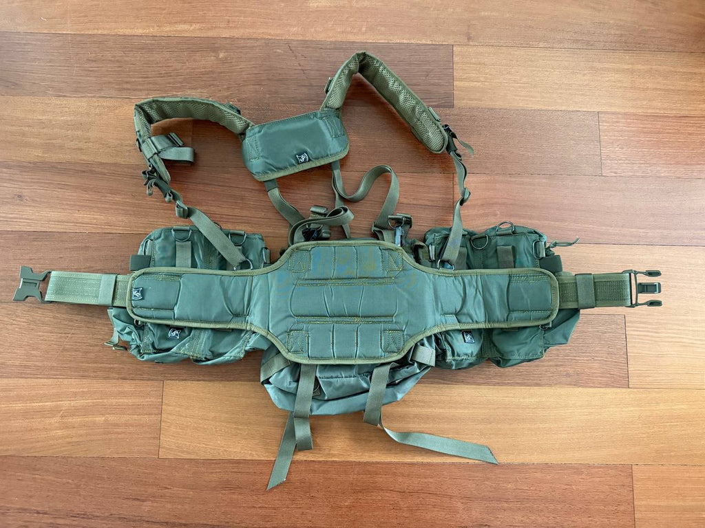 Russian SSO (SPOSN) Smersh Load Bearing Rig - Olive Drab laid flat on wooden floor, showing padded shoulder straps and multiple compartments for carrying gear, Russian surplus.
