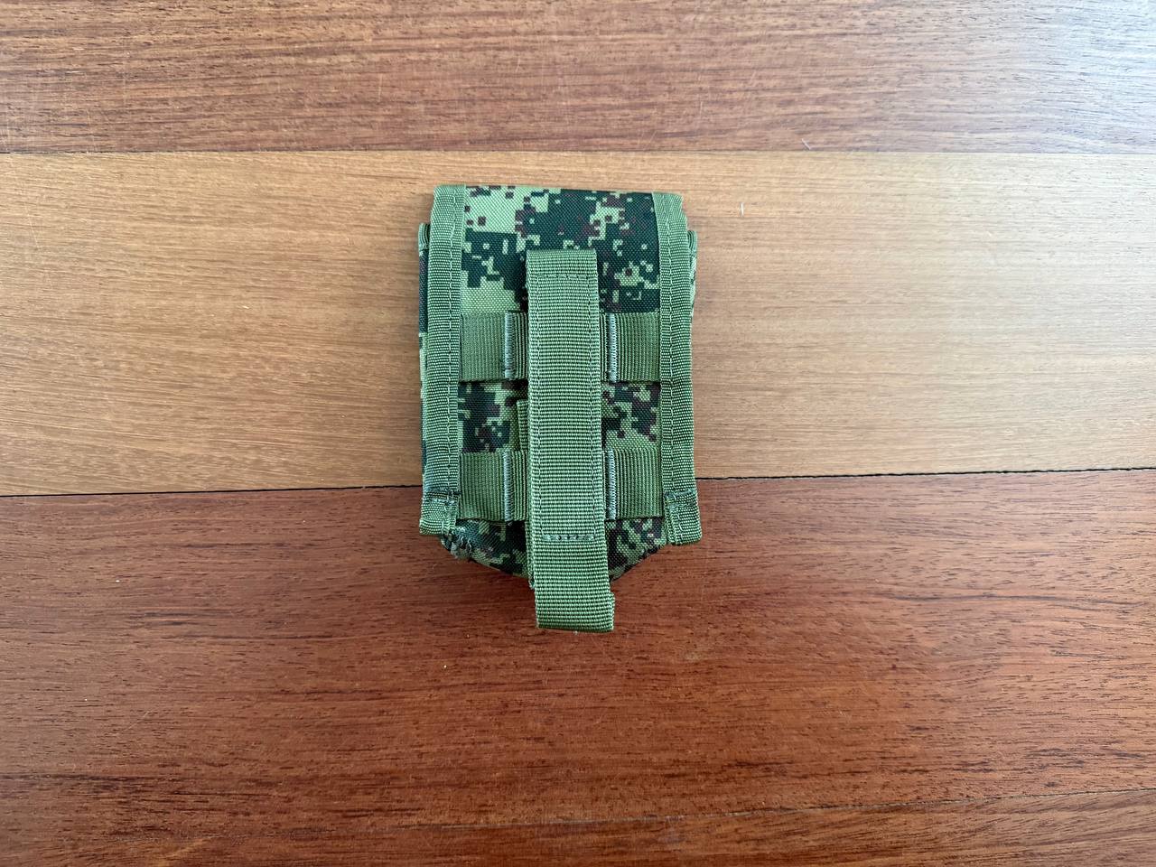 Compact Russian Triada-TKO Utility Pouch - EMR Camo with MOLLE straps, designed for durable and versatile carrying, shown on a wooden surface.