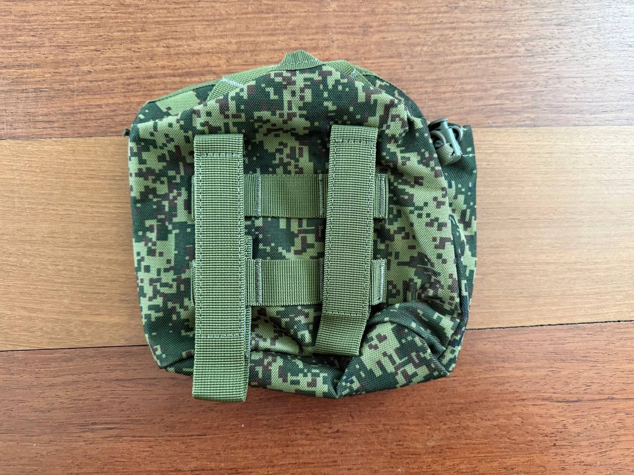 Russian Triada-TKO Water Canteen Pouch - EMR Camo displayed on a wooden surface, featuring sturdy straps and durable digital camouflage fabric in green and black shades.