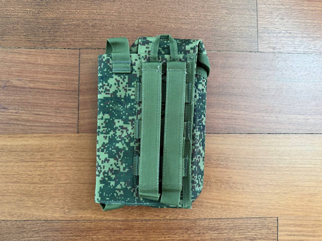 Russian Triada-TKO Left-Handed AK Dual Mag Pouch with ROP Flare - EMR Camo shown flat on wooden surface, featuring digital camouflage and sturdy straps for secure attachment.