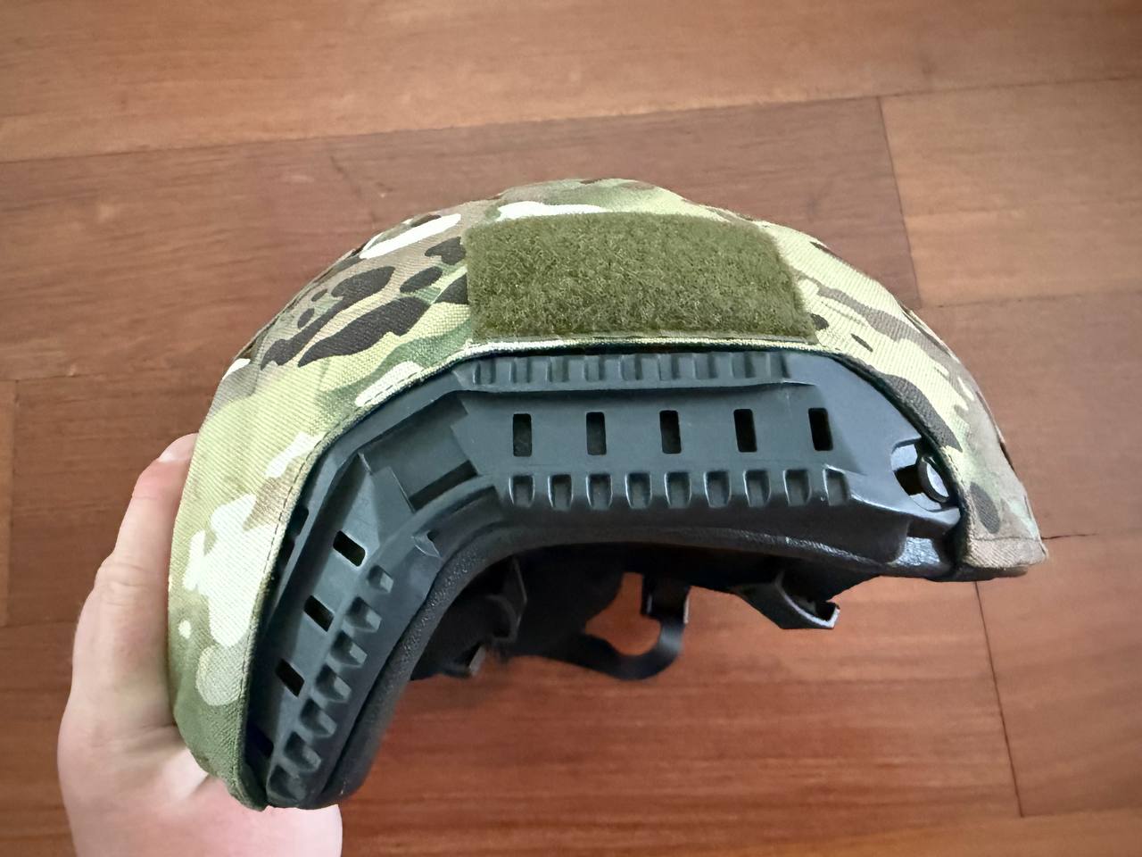 Russian LShZ 1+ Highcut Opscore Helmet - Size 3 + Multicam Cover held in hand showing side profile with ventilation slots and camouflage pattern, Russian surplus tactical gear.