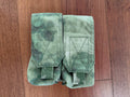 Warrior Assault Systems 4-Cell Mag Pouch - A-TACS FG Camo - Russian Style featuring durable fabric in green camouflage pattern designed for tactical use, laid flat on wooden surface.