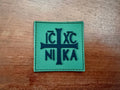 Russian Orthodox "IC XC NIKA" PVC Olive/Black - Military Patch featuring a black cross with Cyrillic letters on an olive green background, suitable for Russian surplus collections.