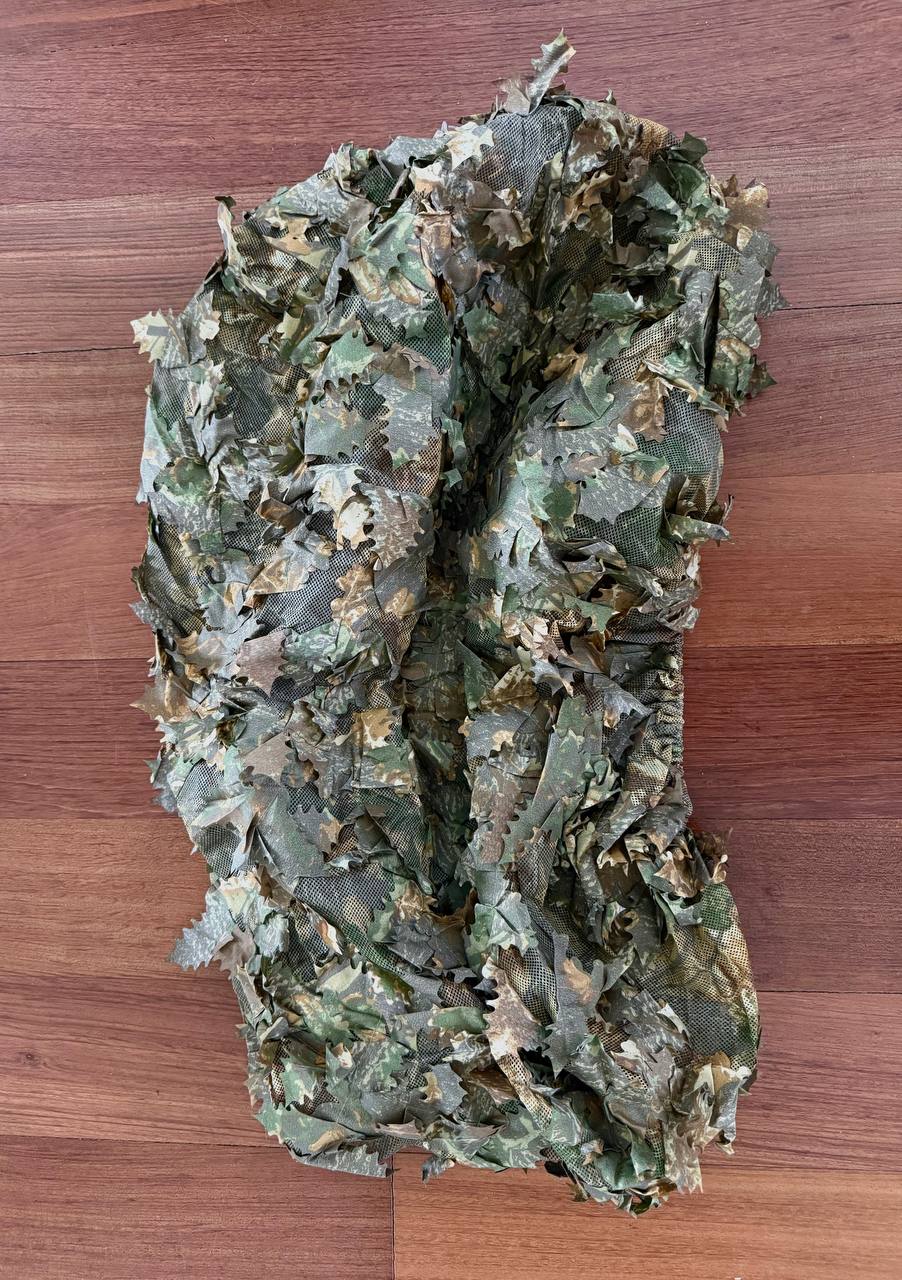 Russian Sokl Leaf Backpack Cover (60L) - Autumn Pattern displaying realistic leaf-shaped camouflage in shades of green and brown, designed for outdoor use on wooden surface.