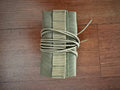 Russian Suppressor Cover for Tactical Silencers - 14cm Length - Tan, folded compactly with securing straps, displayed on a wooden surface.